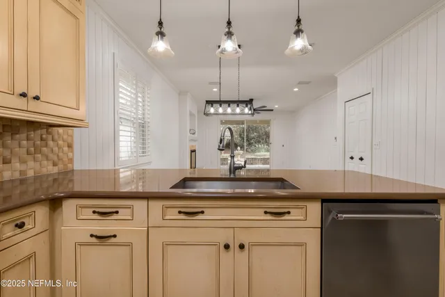 a view of a kitchen with a sink and a stove top oven