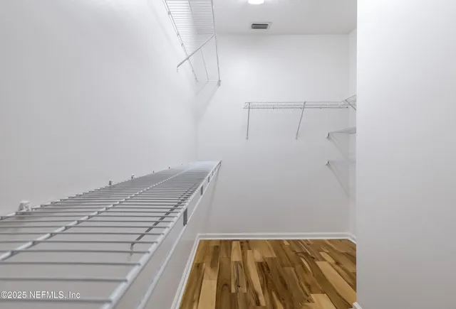 a bathroom with a toilet a sink a mirror a shower a vanity and window