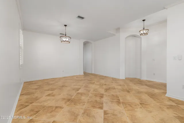 a kitchen with stainless steel appliances granite countertop a sink a window and white cabinets