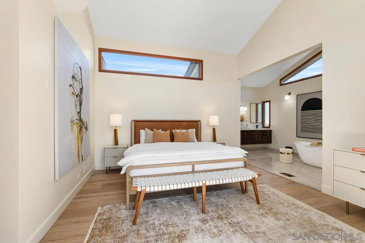 7911 El Paseo Grande La Jolla, CA 92037 - Photo 18 of 32 a bedroom with a bed and a table in it