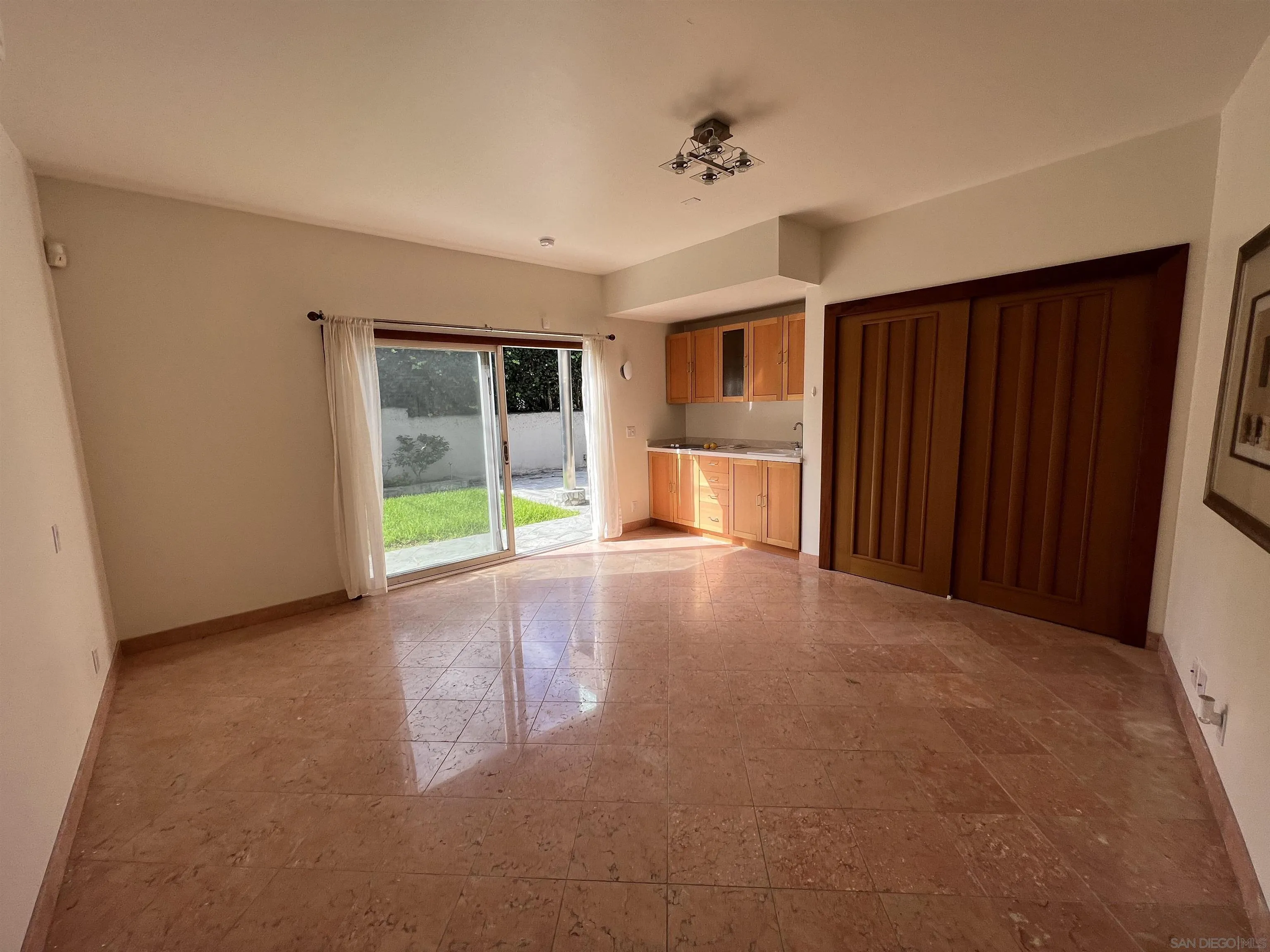 7911 El Paseo Grande La Jolla, CA 92037 - Photo 29 of 32 a view of a livingroom with a fireplace and cabinet