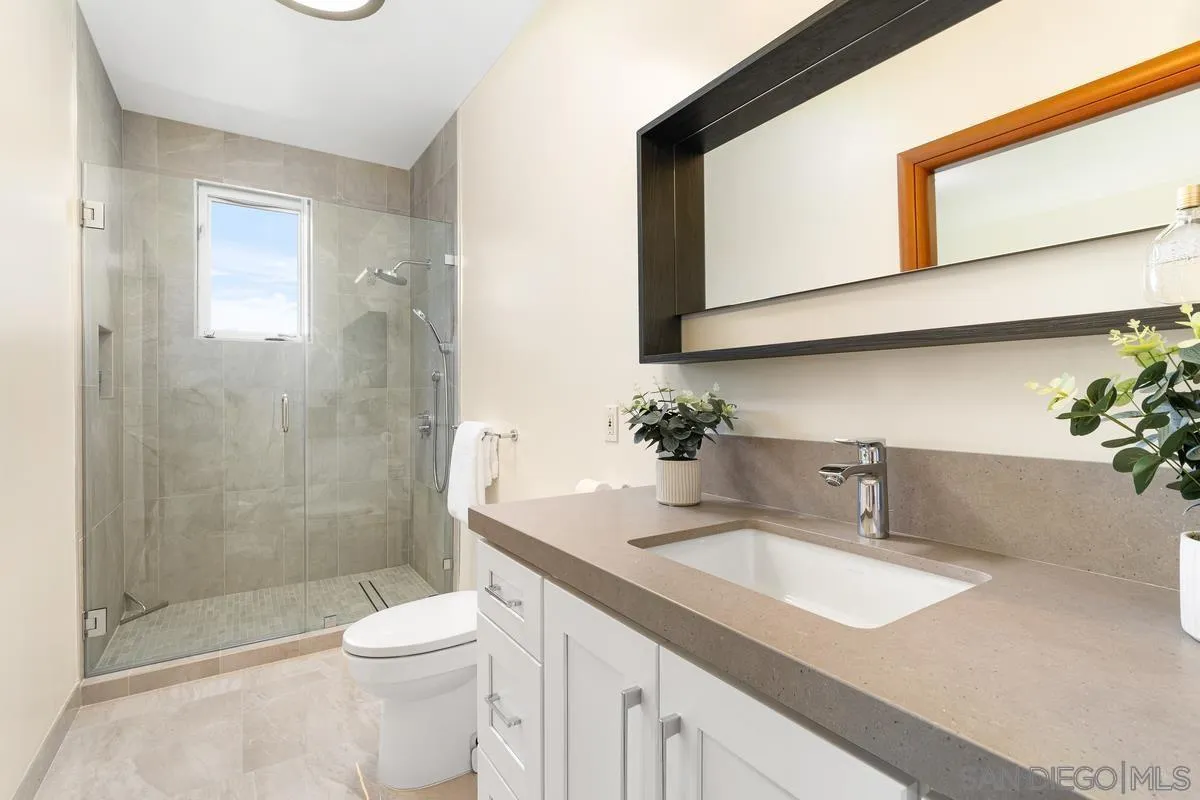 7911 El Paseo Grande La Jolla, CA 92037 - Photo 10 of 32 a bathroom with a sink toilet and shower