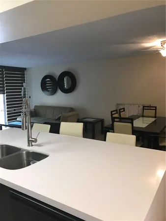 a view of a kitchen with a sink and cabinets