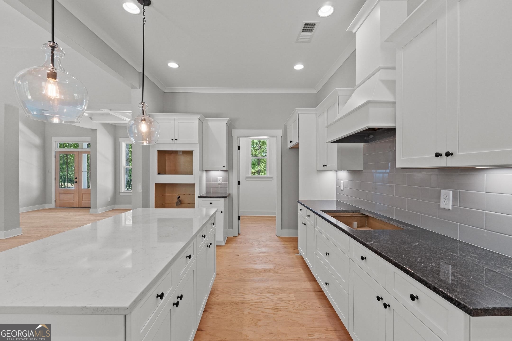 2000 Millstream Court Griffin, GA 30224 - Photo 13 of 49 a large kitchen with stainless steel appliances kitchen island granite countertop a sink and cabinets