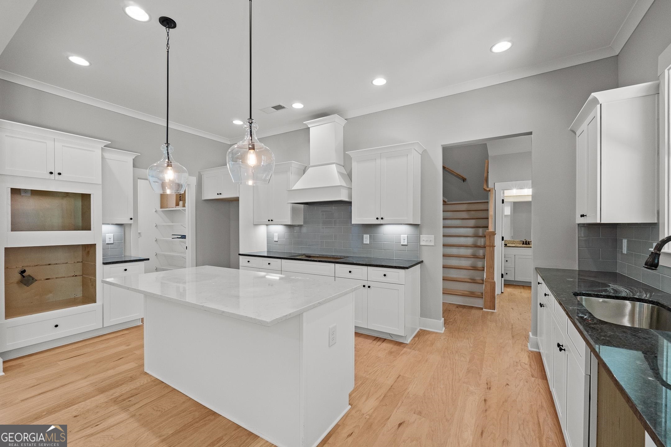 2000 Millstream Court Griffin, GA 30224 - Photo 14 of 49 a large kitchen with stainless steel appliances kitchen island a large island a sink stainless steel appliances and cabinets