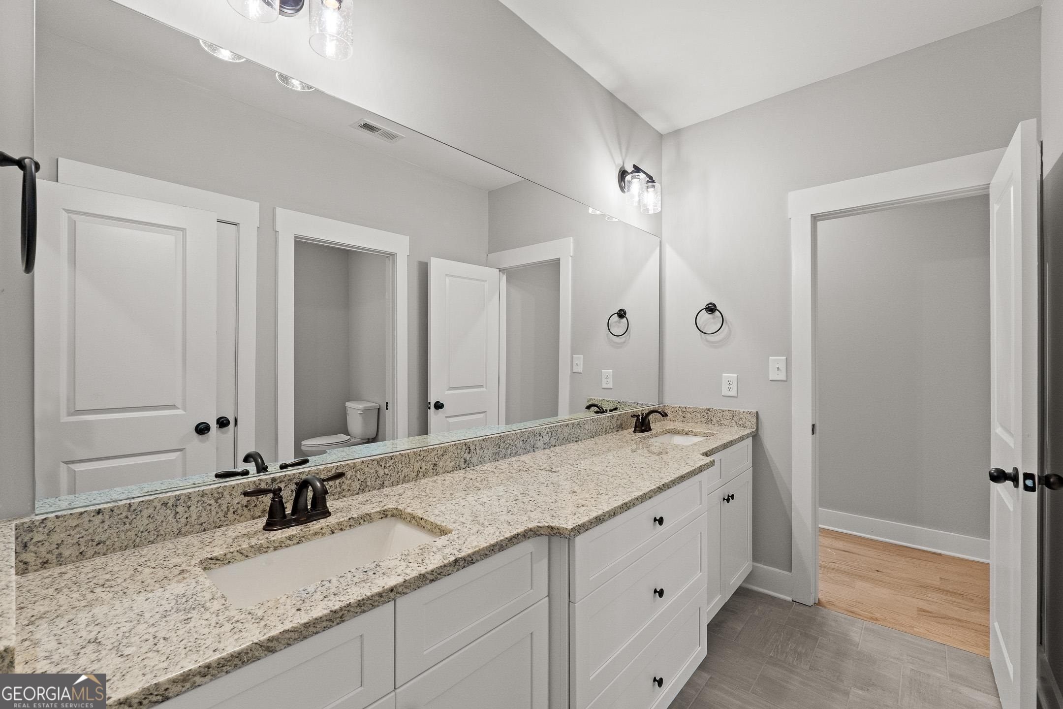 2000 Millstream Court Griffin, GA 30224 - Photo 31 of 49 a bathroom with a granite countertop sink and a mirror