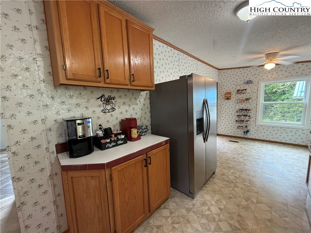 304 The Mulberry Cove Road Boone, NC 28607 - Photo 11 of 45 a kitchen with stainless steel appliances granite countertop a refrigerator stove and sink