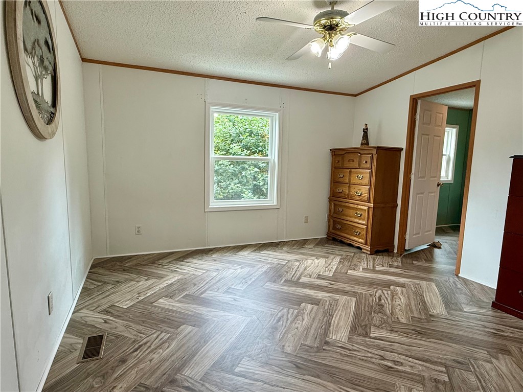 304 The Mulberry Cove Road Boone, NC 28607 - Photo 17 of 45 a view of an empty room with a window and a ceiling fan