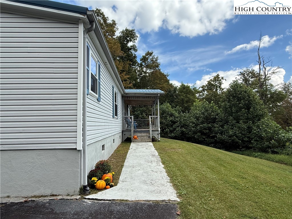 304 The Mulberry Cove Road Boone, NC 28607 - Photo 2 of 45 a view of backyard with barbeque grill and wooden stairs