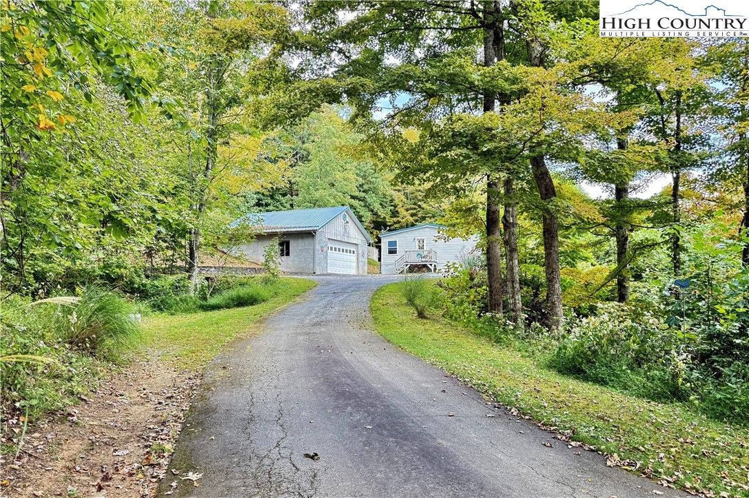 304 The Mulberry Cove Road Boone, NC 28607 - Photo 30 of 45 a front view of a house with a yard and garage