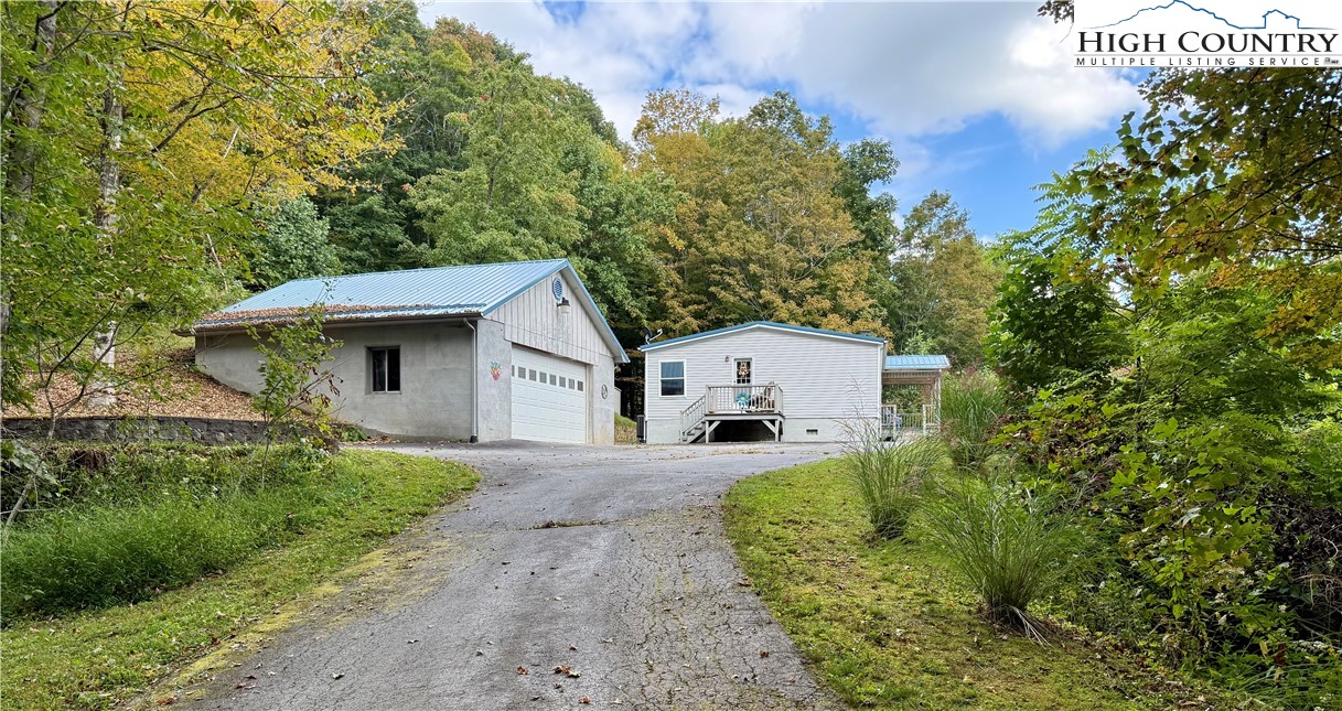 304 The Mulberry Cove Road Boone, NC 28607 - Photo 31 of 45 a front view of a house with a yard and garage