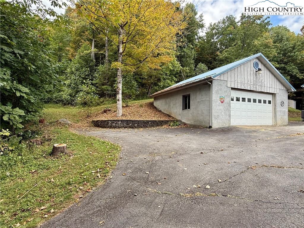304 The Mulberry Cove Road Boone, NC 28607 - Photo 33 of 45 a view of a house with backyard and trees