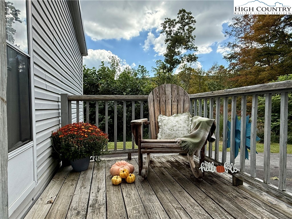 304 The Mulberry Cove Road Boone, NC 28607 - Photo 37 of 45 a view of balcony with wooden floor and outdoor seating