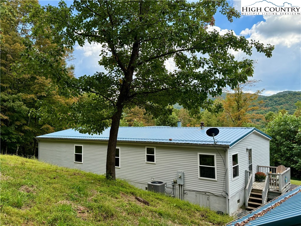 304 The Mulberry Cove Road Boone, NC 28607 - Photo 43 of 45 a white house that has tree in front of it