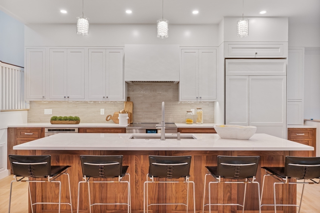 65 Francis Street Brookline, MA 02446 - Photo 11 of 35 a kitchen with a stove a refrigerator and a sink