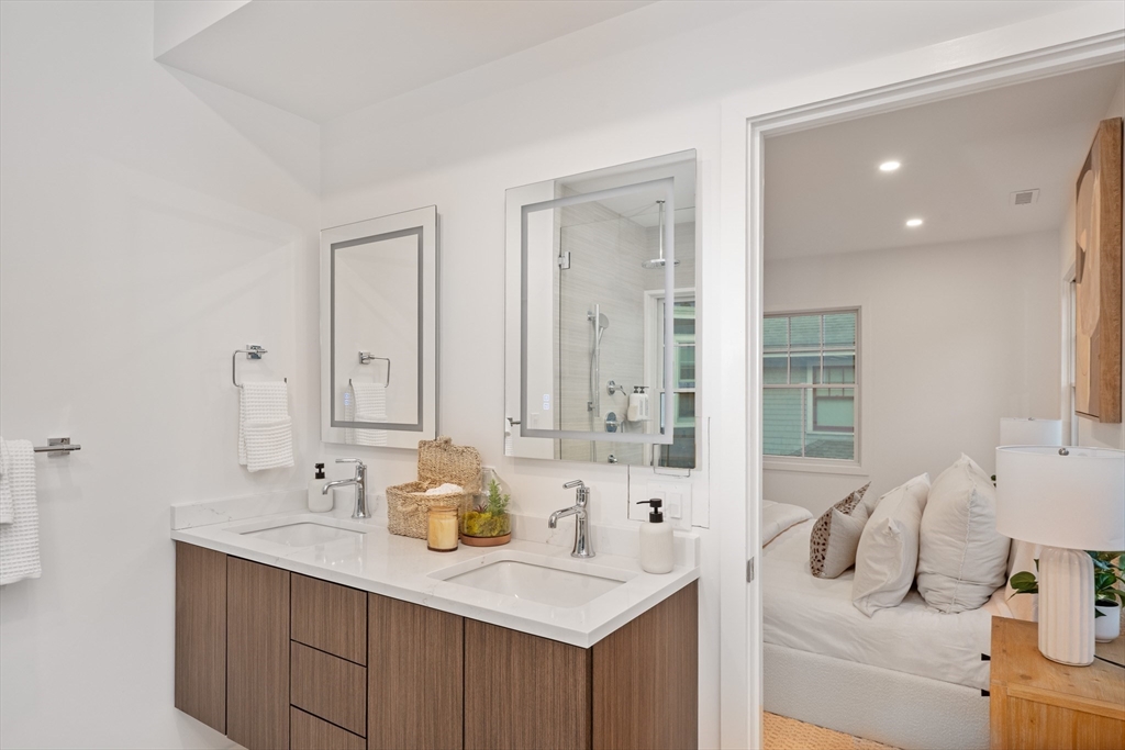 65 Francis Street Brookline, MA 02446 - Photo 20 of 35 a bathroom with a sink vanity granite tub shower and a mirror