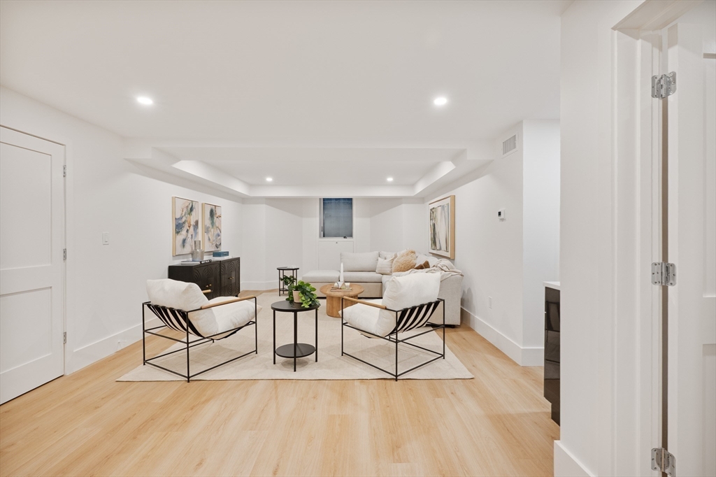 65 Francis Street Brookline, MA 02446 - Photo 22 of 35 a living room with furniture and a wooden floor