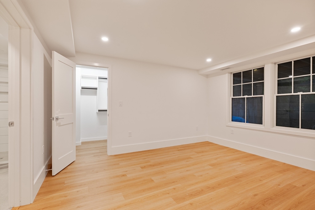 65 Francis Street Brookline, MA 02446 - Photo 31 of 35 a view of an empty room with wooden floor and entryway