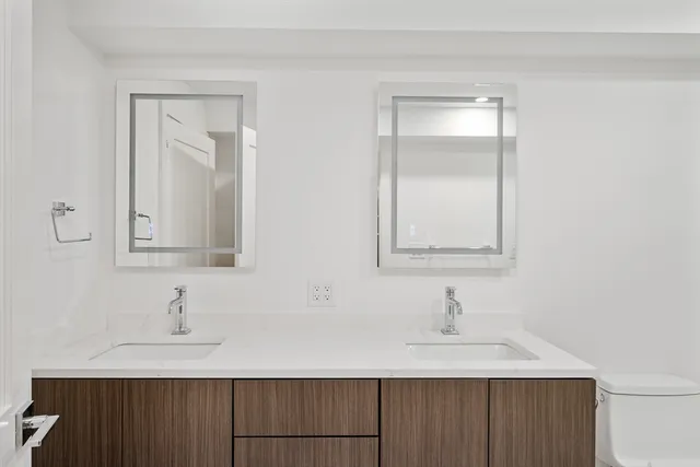 a bathroom with a bathtub shower sink vanity and toilet