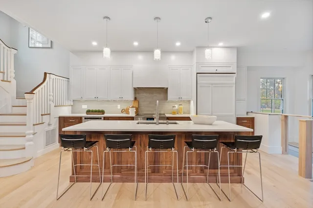 a kitchen with a stove a refrigerator and a sink