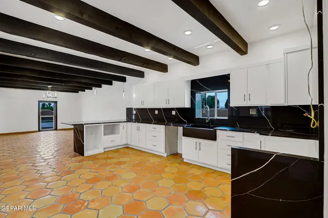a kitchen with a sink and a refrigerator