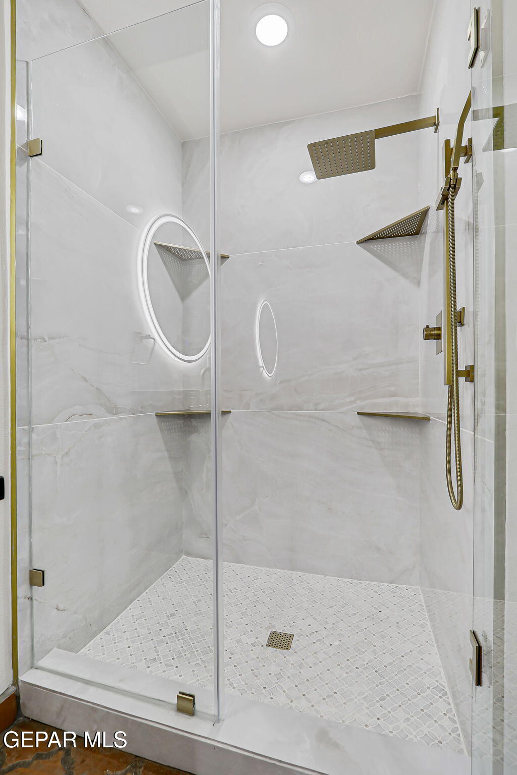 1067 Gardner Road El Paso, TX 79932 - Photo 18 of 59 a bathroom with a glass shower door