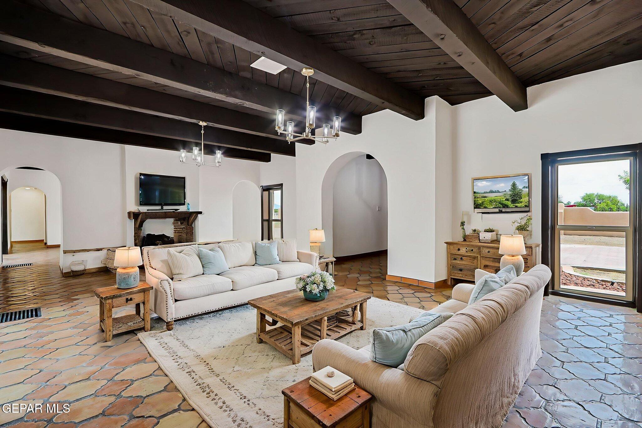 1067 Gardner Road El Paso, TX 79932 - Photo 3 of 59 a living room with furniture and a chandelier