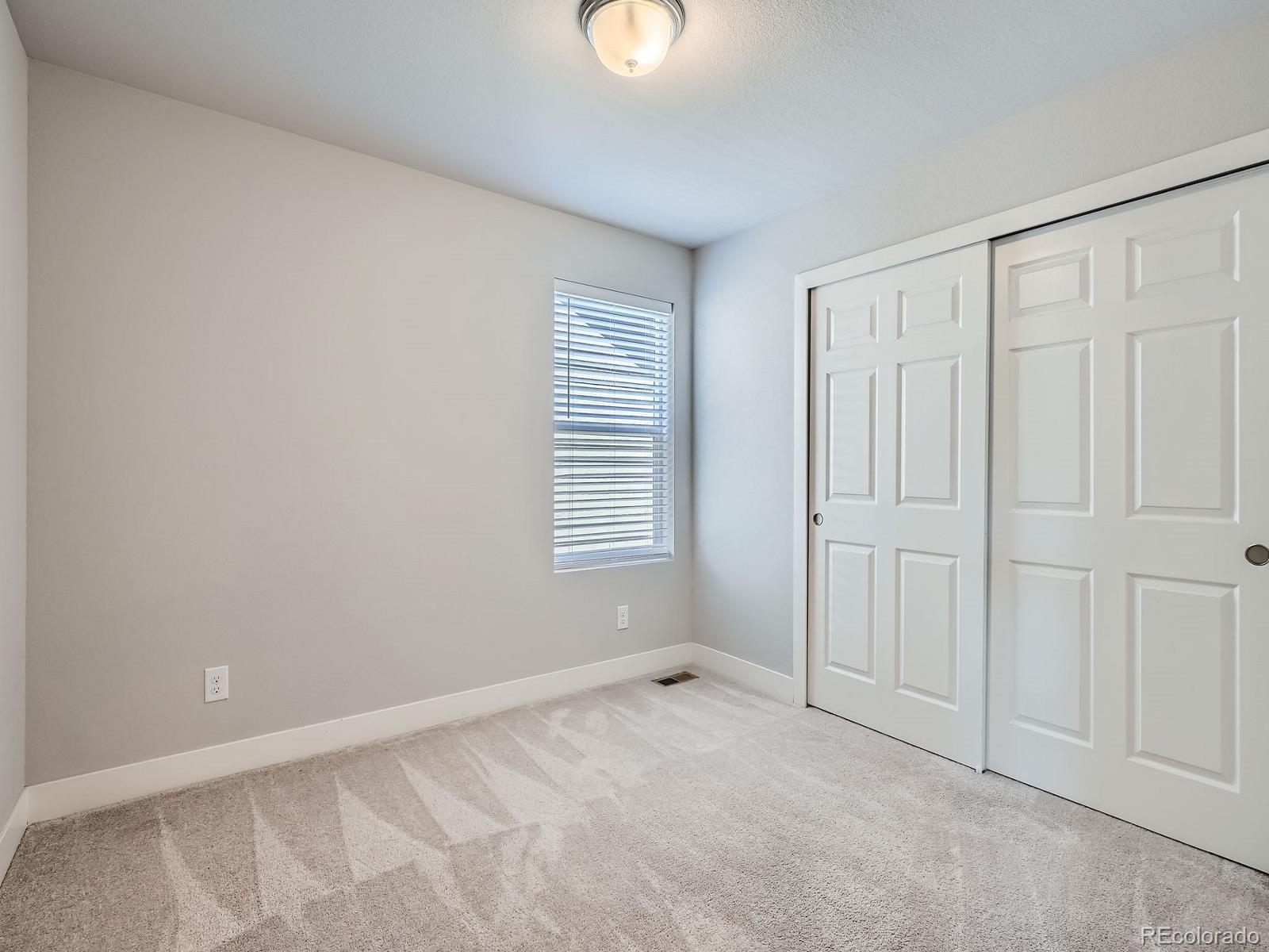 4773 Kittredge Street Denver, CO 80239 - Photo 18 of 32 a view of an empty room with a window