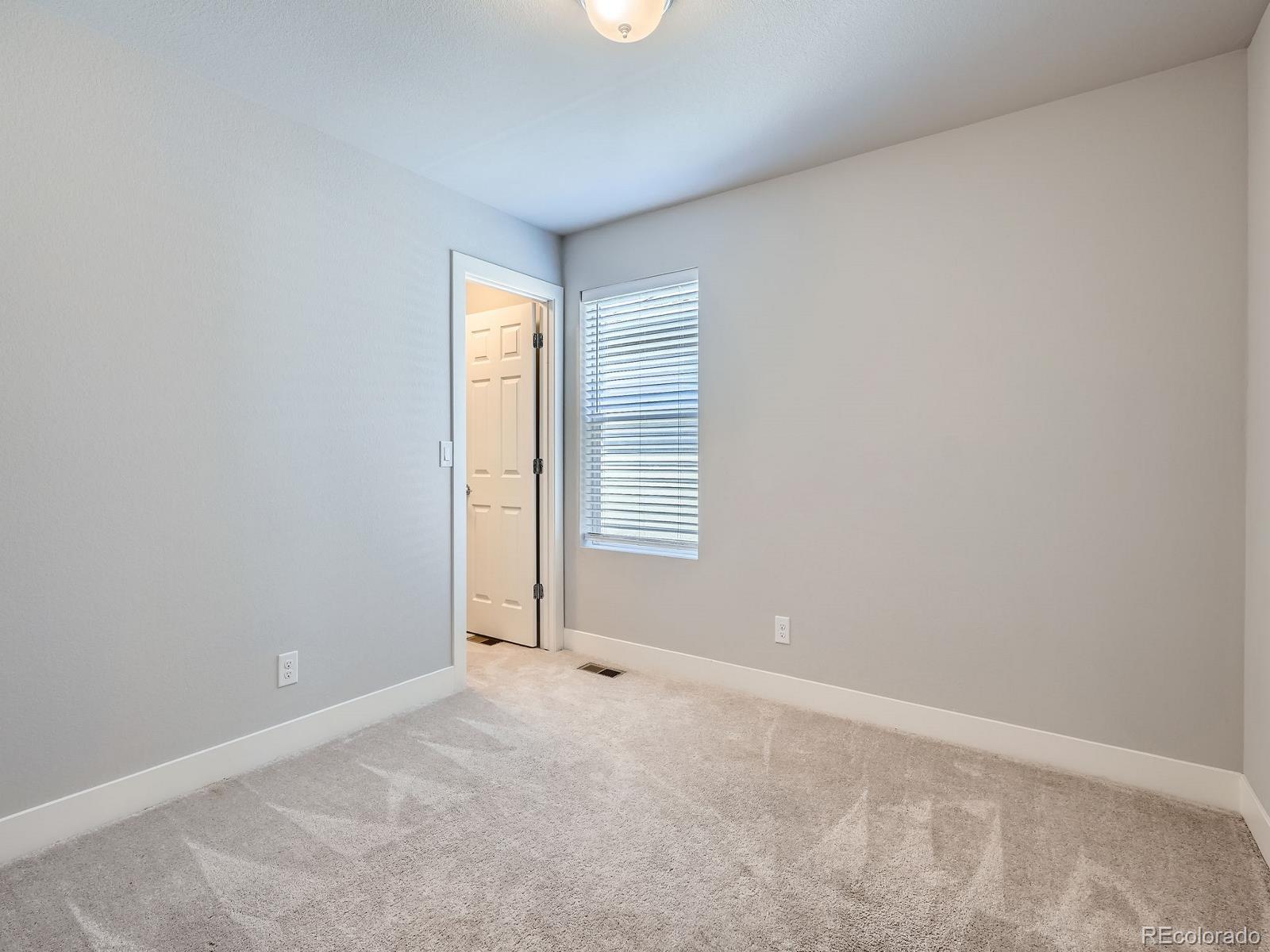 4773 Kittredge Street Denver, CO 80239 - Photo 19 of 32 a view of an empty room with a window