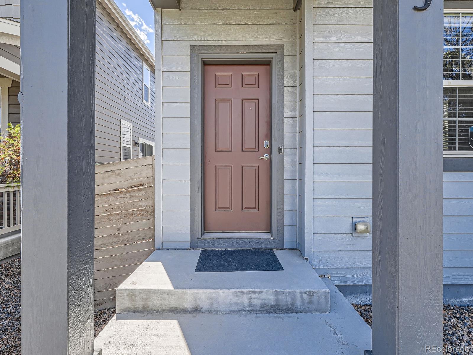 4773 Kittredge Street Denver, CO 80239 - Photo 2 of 32 a view of wooden door and a window