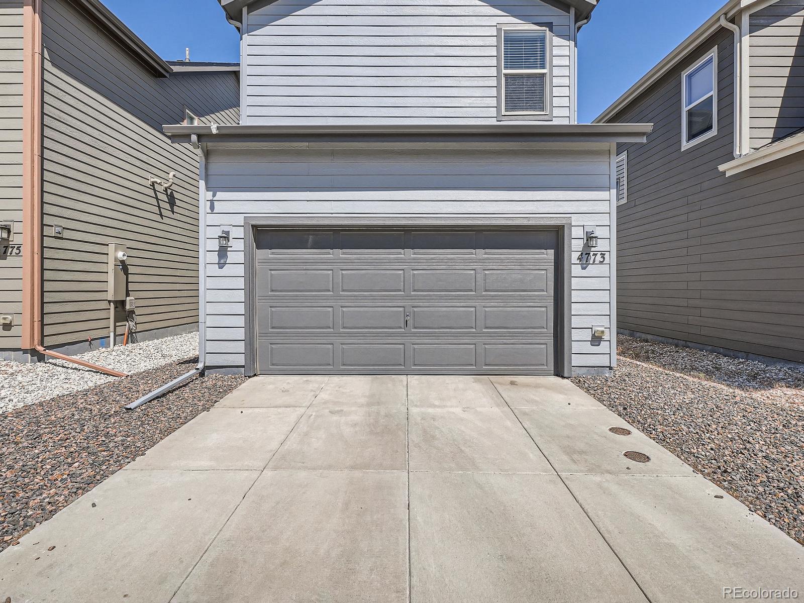 4773 Kittredge Street Denver, CO 80239 - Photo 27 of 32 a front view of a house with garage