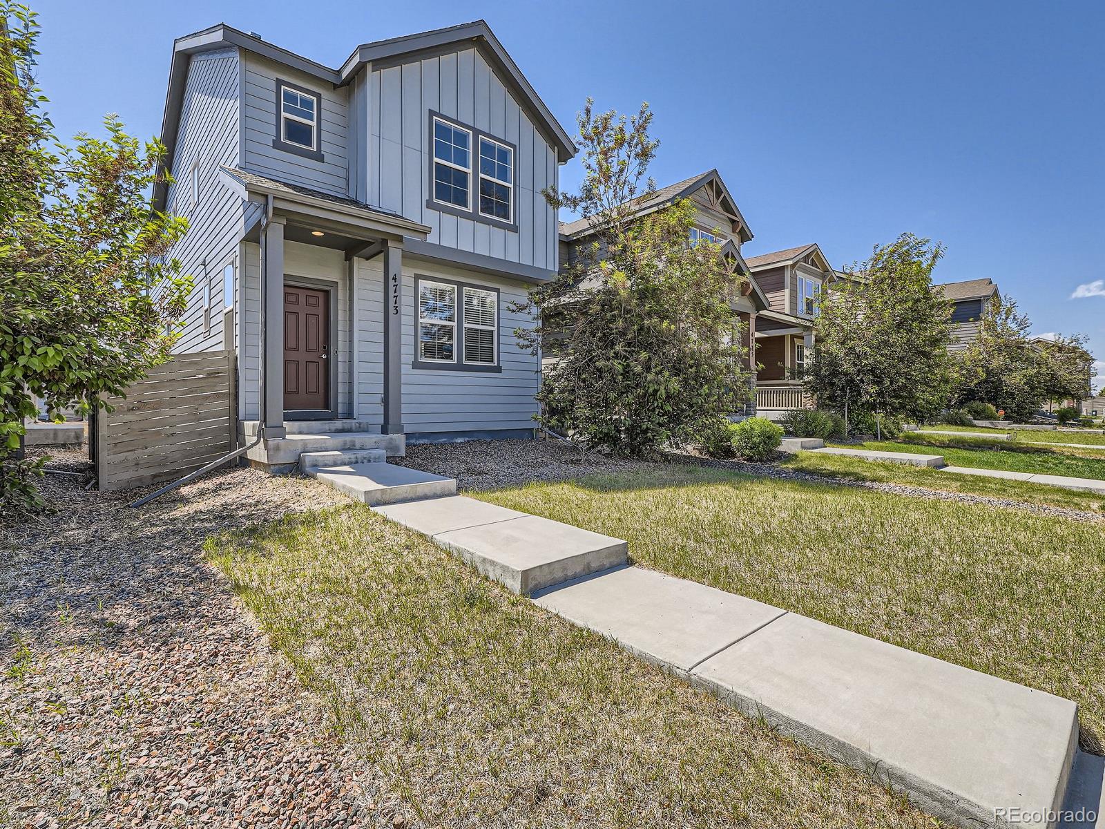 4773 Kittredge Street Denver, CO 80239 - Photo 28 of 32 a view of a house with a yard