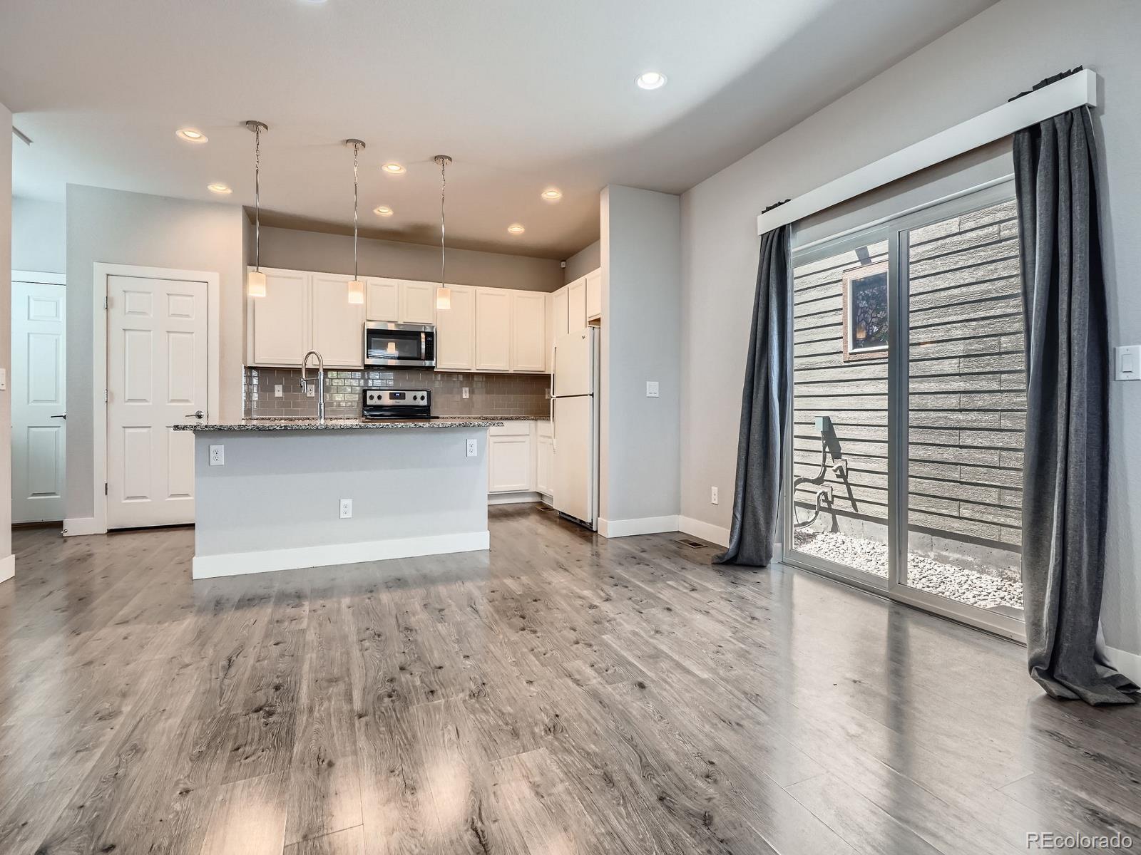 4773 Kittredge Street Denver, CO 80239 - Photo 7 of 32 a view of kitchen with wooden floor and electronic appliances