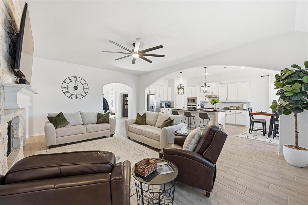 4425 Dandelion Lane Midlothian, TX 76065 - Photo 10 of 40 a living room with furniture a flat screen tv and a dining table with wooden floor