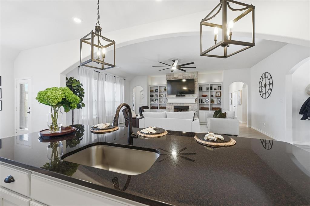 4425 Dandelion Lane Midlothian, TX 76065 - Photo 15 of 40 a kitchen with a sink and chandelier