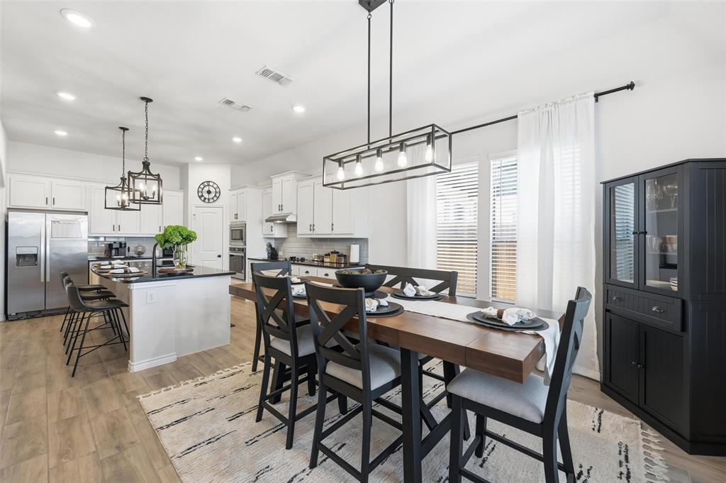 4425 Dandelion Lane Midlothian, TX 76065 - Photo 17 of 40 a view of a dining room and livingroom with furniture wooden floor a chandelier