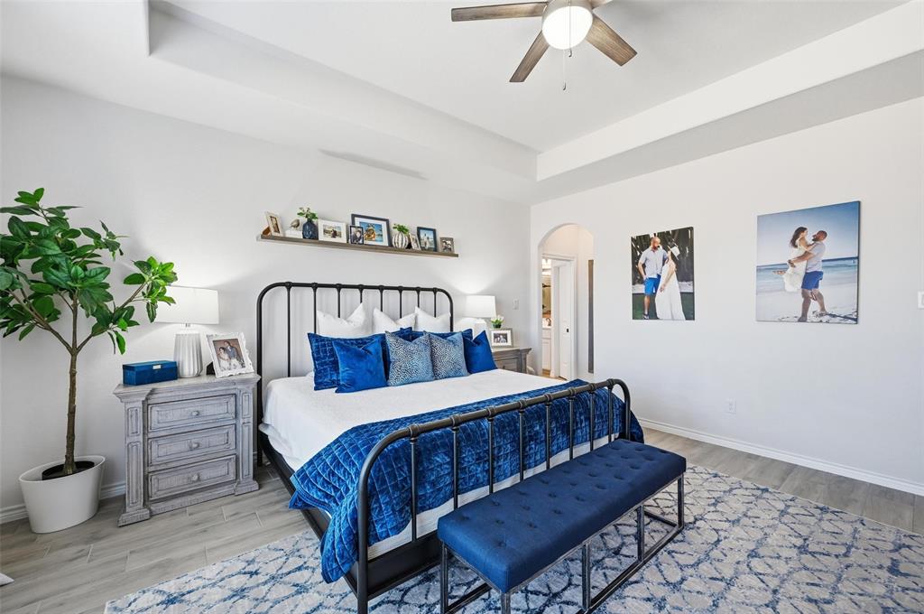 4425 Dandelion Lane Midlothian, TX 76065 - Photo 19 of 40 a bedroom with a large bed and a potted plant