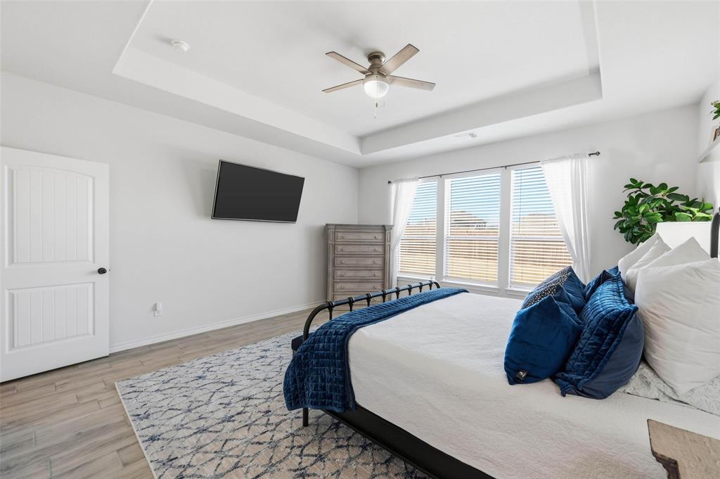 4425 Dandelion Lane Midlothian, TX 76065 - Photo 21 of 40 a spacious bedroom with a bed and a flat screen tv