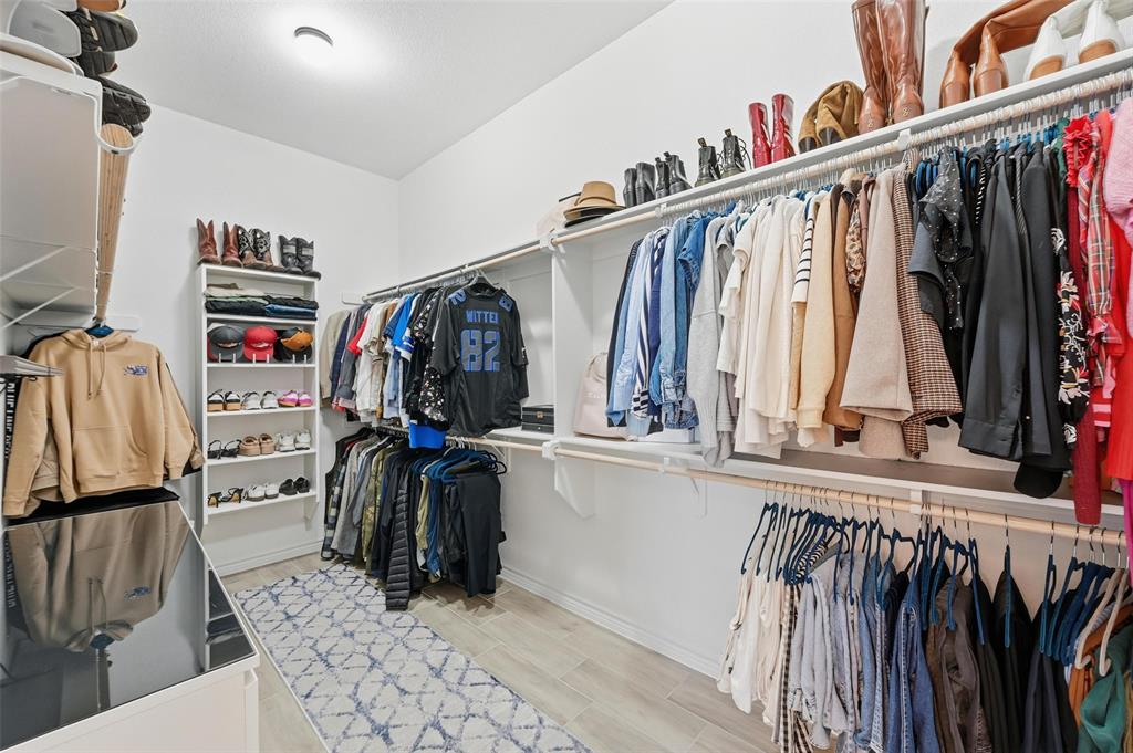 4425 Dandelion Lane Midlothian, TX 76065 - Photo 26 of 40 a view of walk in closet with clothes and shoes