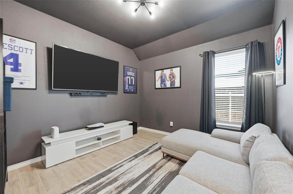 4425 Dandelion Lane Midlothian, TX 76065 - Photo 29 of 40 a living room with furniture and a flat screen tv