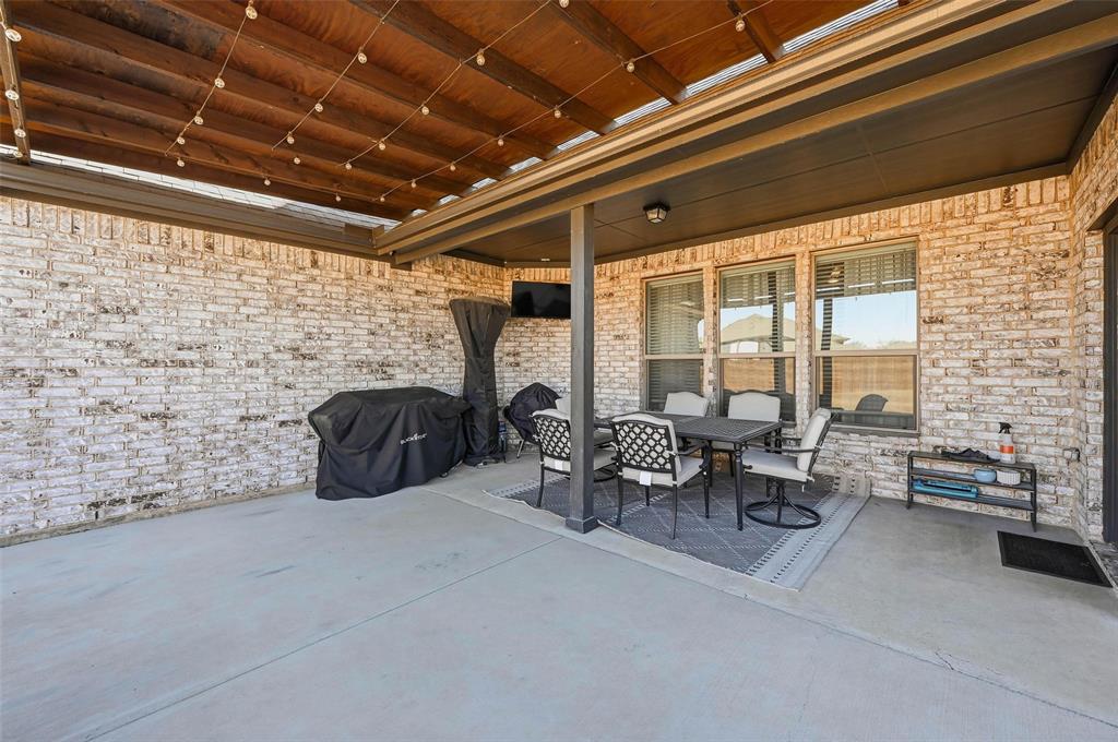 4425 Dandelion Lane Midlothian, TX 76065 - Photo 33 of 40 a living room with furniture and a fireplace