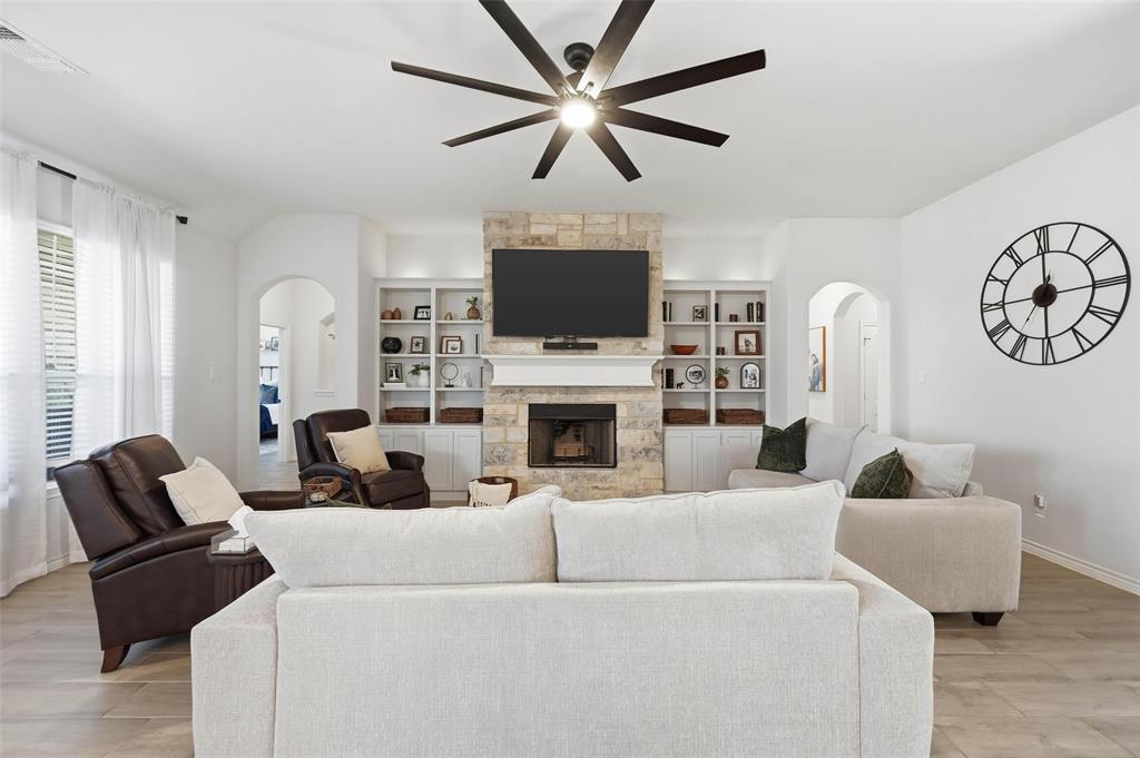 4425 Dandelion Lane Midlothian, TX 76065 - Photo 7 of 40 a living room with furniture a flat screen tv and a fireplace