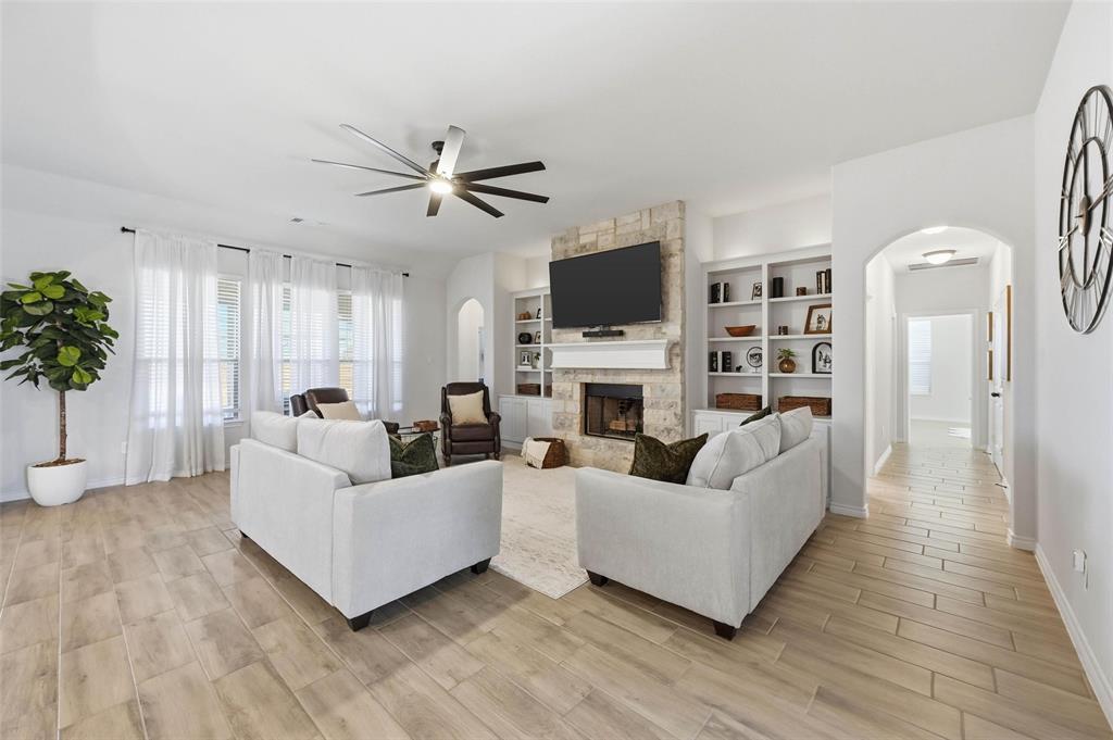 4425 Dandelion Lane Midlothian, TX 76065 - Photo 8 of 40 a living room with furniture a fireplace and a flat screen tv