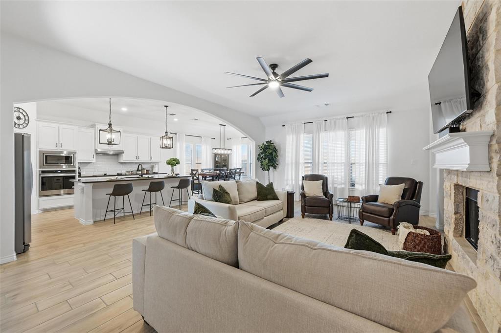 4425 Dandelion Lane Midlothian, TX 76065 - Photo 39 of 40 a living room with furniture a fireplace and a flat screen tv