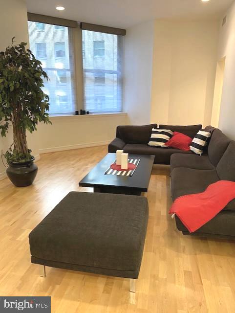 1600-18 Arch Street, Unit 706 Philadelphia, PA 19103 - Photo 3 of 19 a living room with furniture and a potted plant