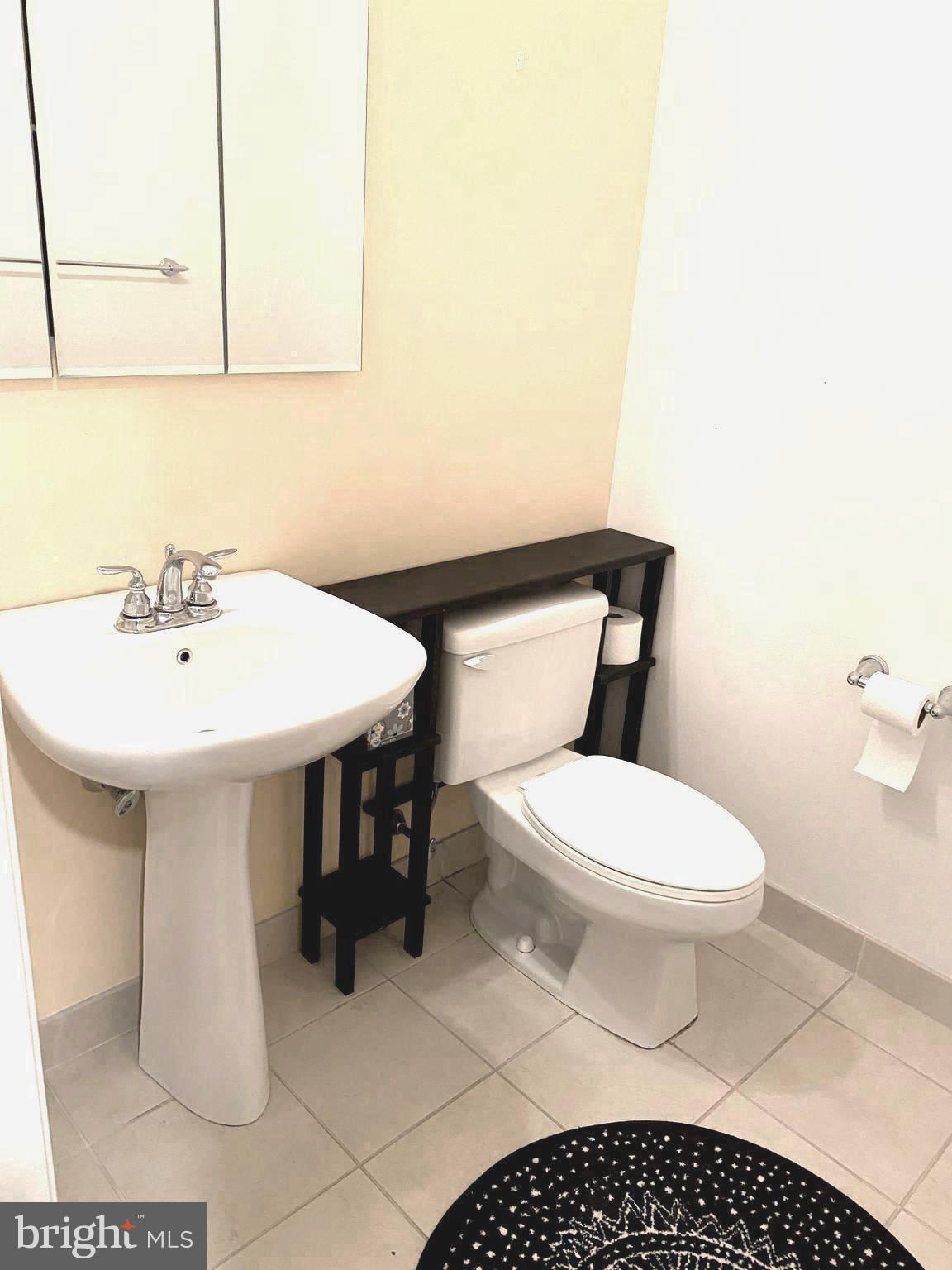 1600-18 Arch Street, Unit 706 Philadelphia, PA 19103 - Photo 8 of 19 a bathroom with a sink toilet and a mirror