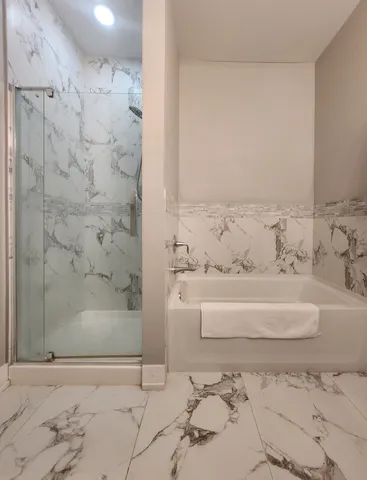 a bathroom with a bathtub and shower