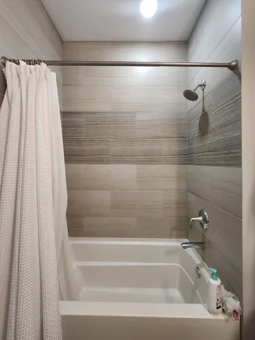 a bathroom with a shower and a bathtub