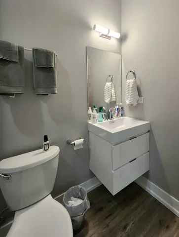 a bathroom with a sink mirror and toilet