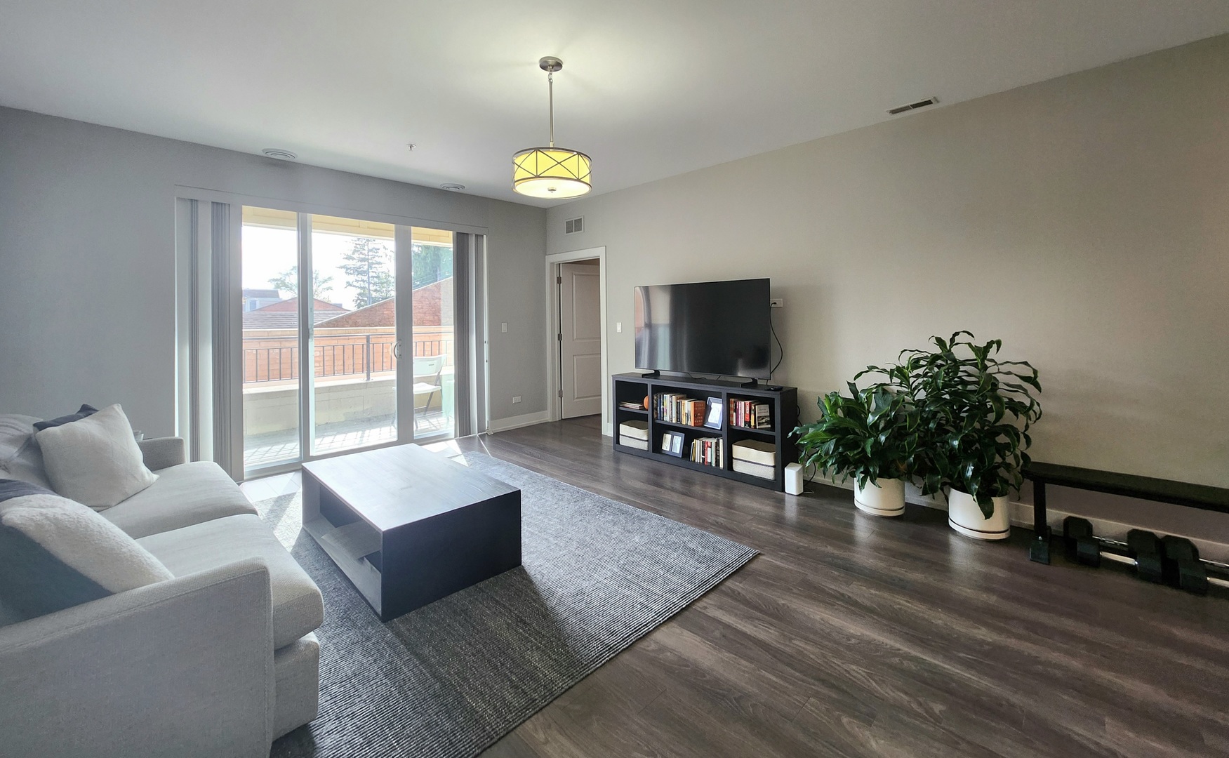 1202 Waukegan Road, Unit 201 Glenview, IL 60025 - Photo 6 of 15 a living room with furniture and a flat screen tv